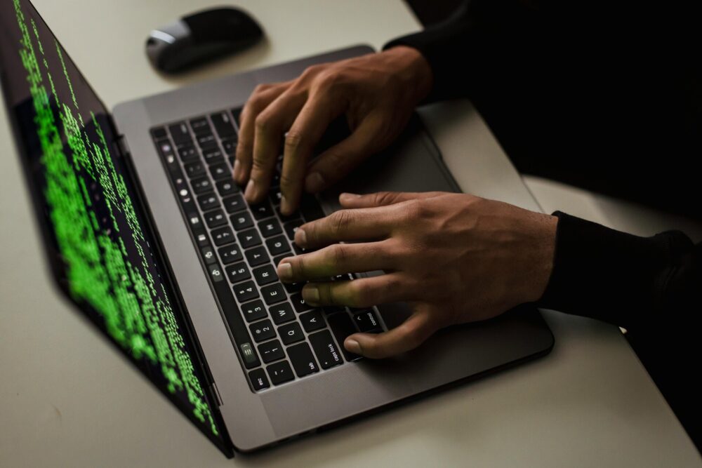 A man typing on a laptop