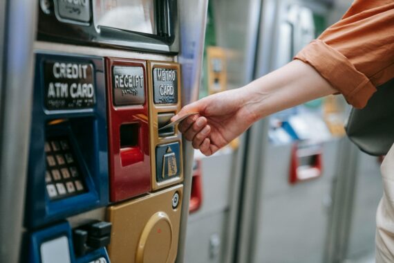 person using an ATM and holding a card