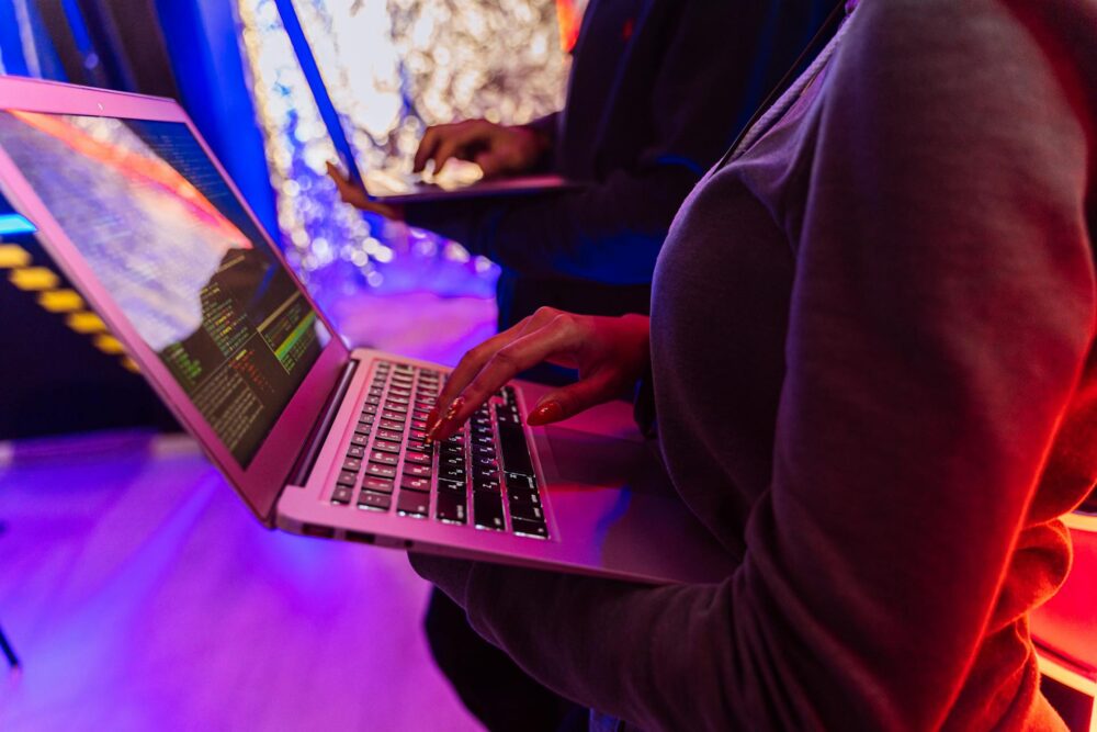 A woman holding a laptop and hacking