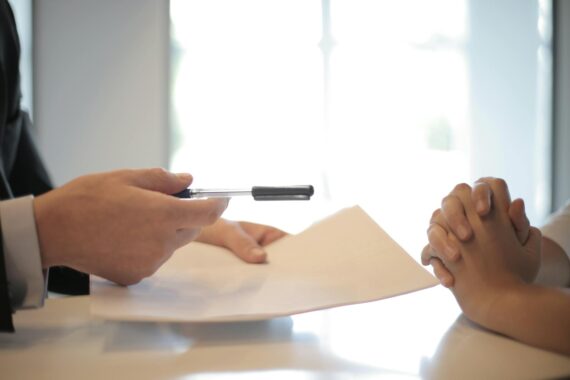 Businessman giving a contract to a woman to sign