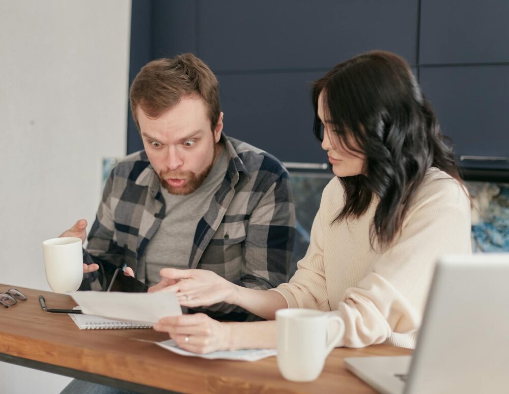 Two people looking at bank statements